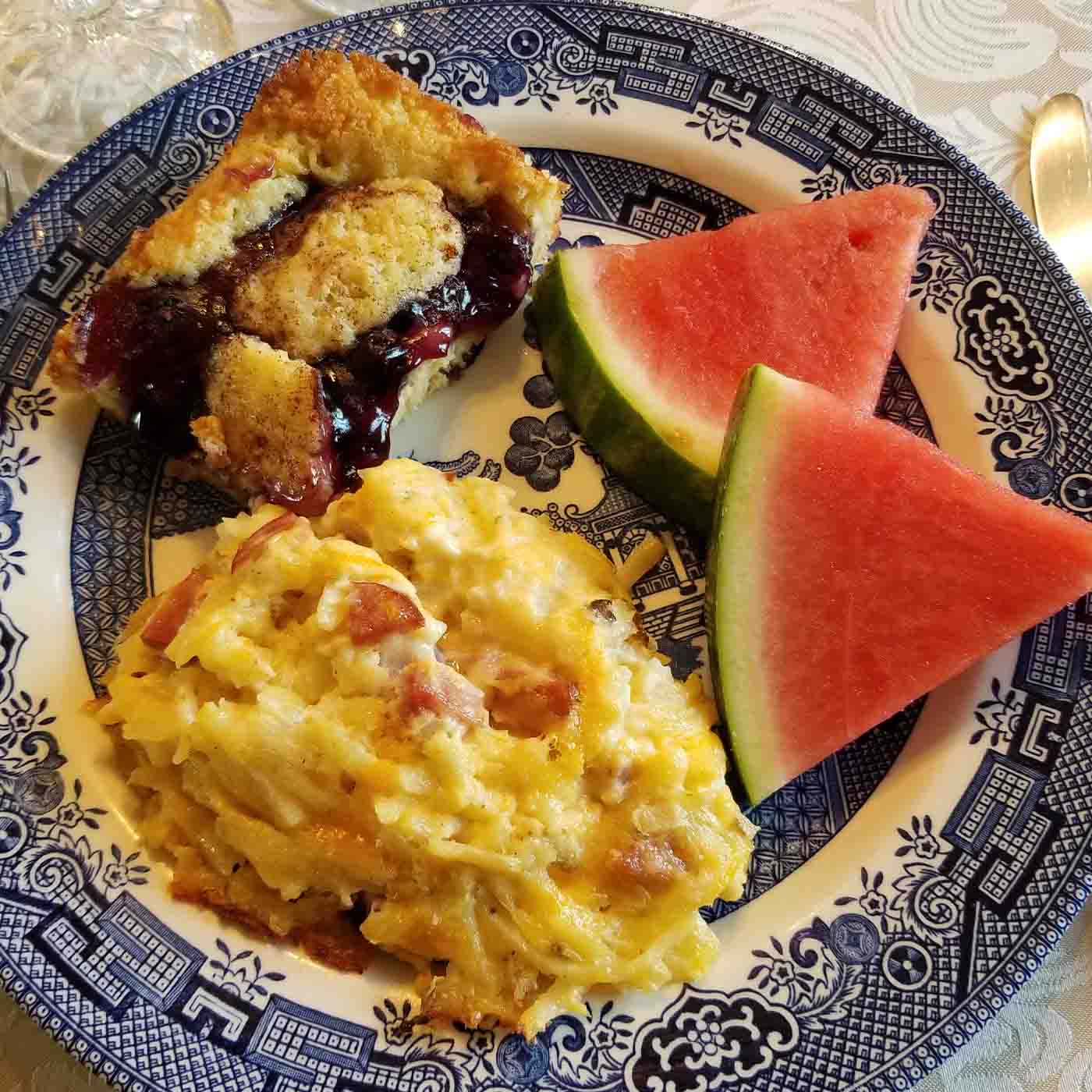 Plate with watermelon, egg dish, and pie.