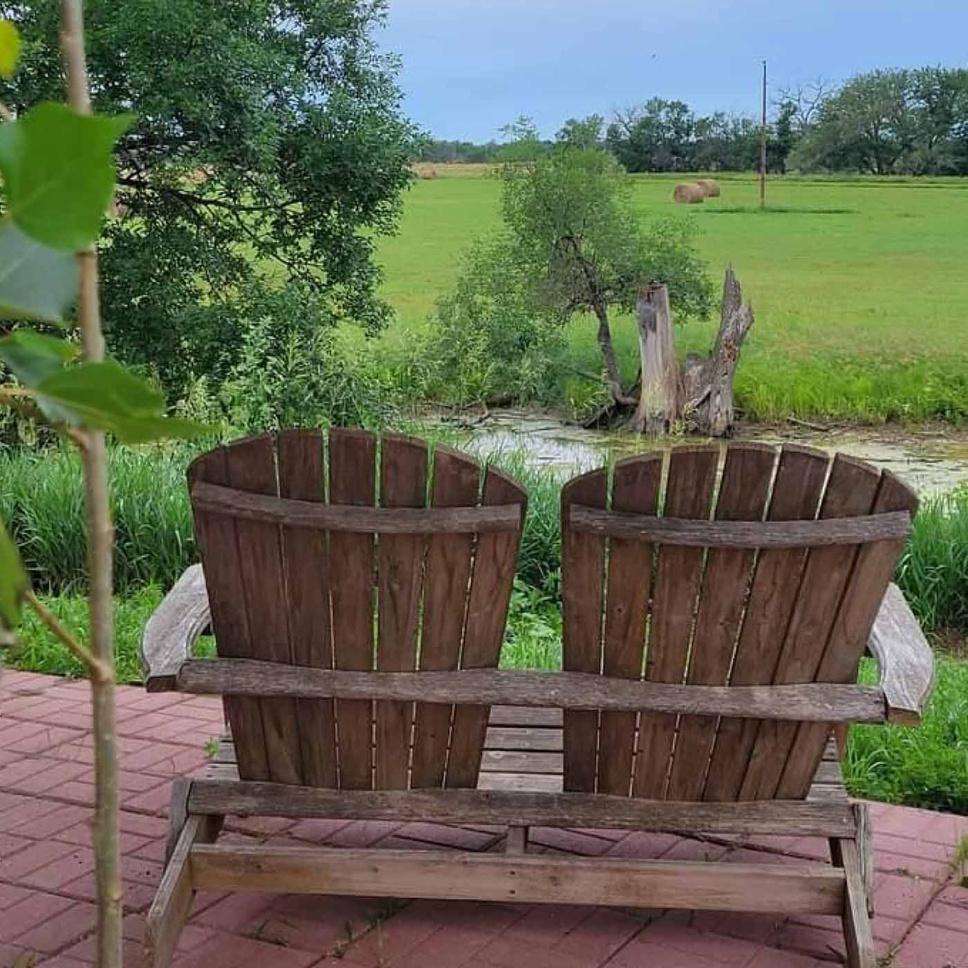 Rustic outdoor chairs in a prairie setting.